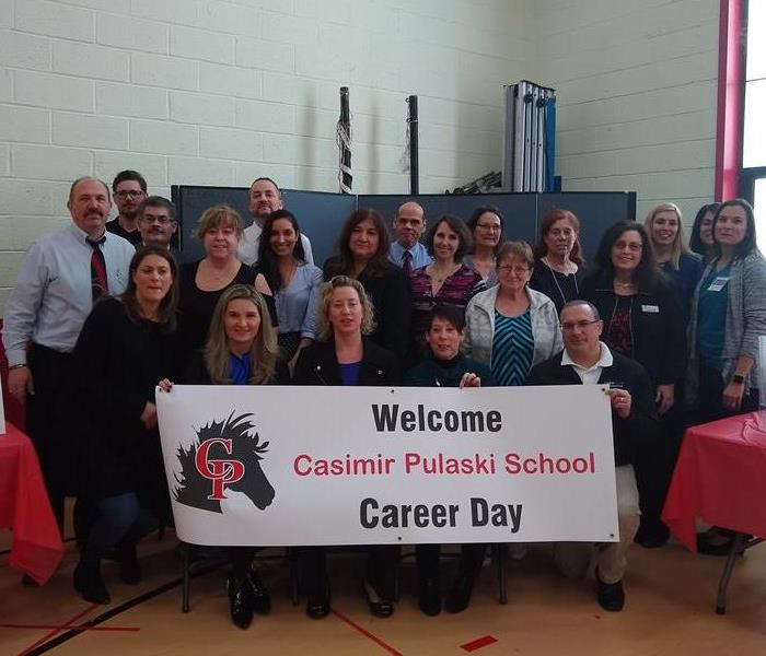group of people in front of a career day sign